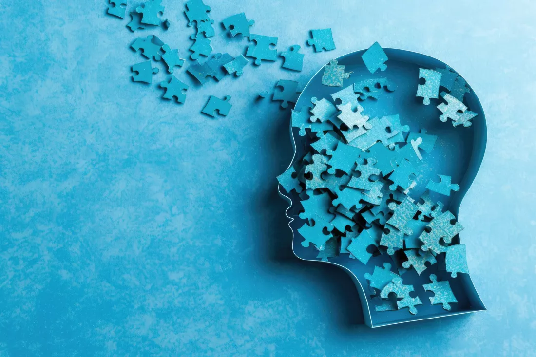 puzzle-shape-human-head-losing-pieces-as-brain-damage-loss-memory-blue-background
